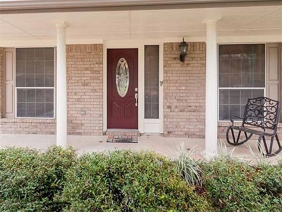 An open front porch invites you to the front door.