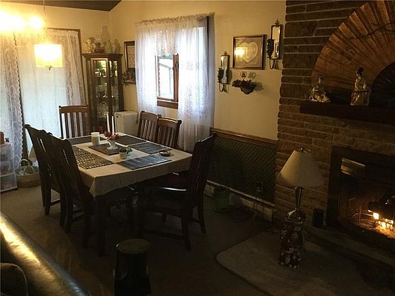 You'll enjoy dining near the cozy fireplace and the peaceful view through the glass doors leading to the outdoor patio.