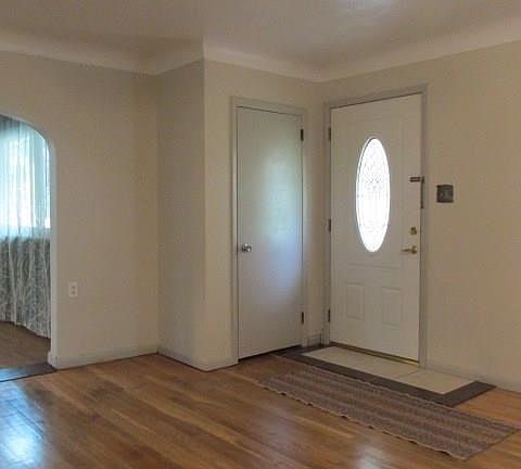 The Entry steps into the Living Room with hardwood floors