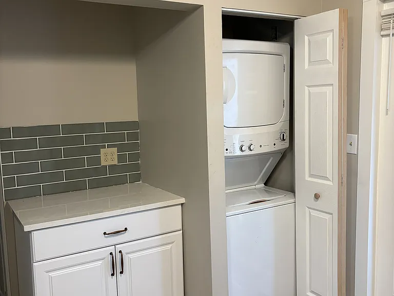 kitchen - breakfast bar and laundry closet. Brand new tile backsplash, quartz countertop, cabinet, and new washer/dryer combo machine.