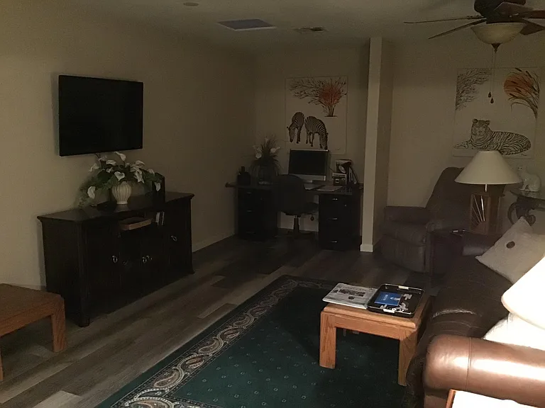 TV Room with desk and sofa with Recliner's.