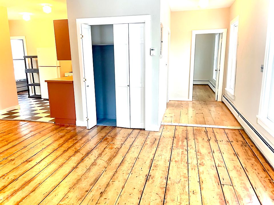 Living room looking into kitchen and right side bedroom