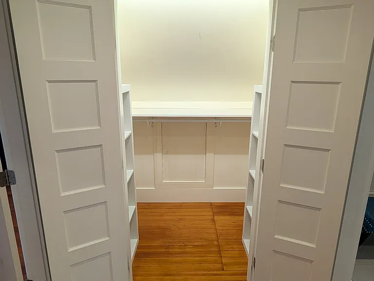 Walk in closet in primary bedroom/bath suite