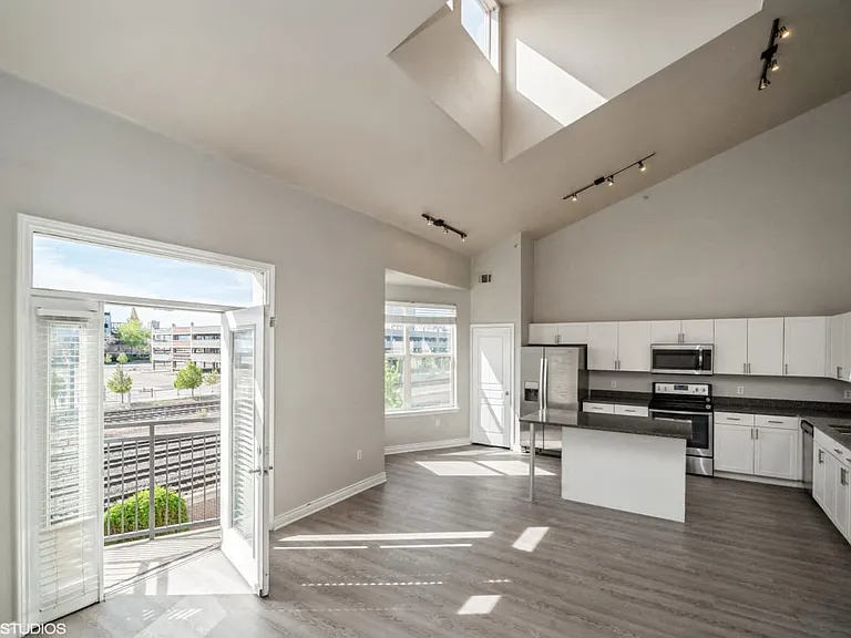 Kitchen features a beautiful view of the living space and the natural beauty outside