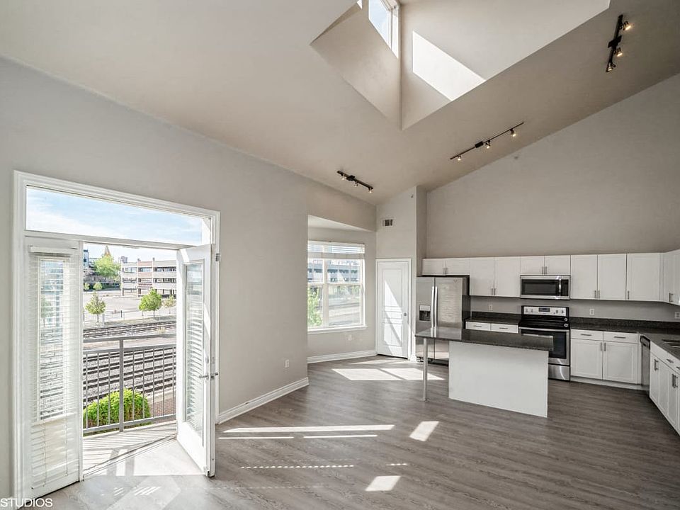 Kitchen features a beautiful view of the living space and the natural beauty outside