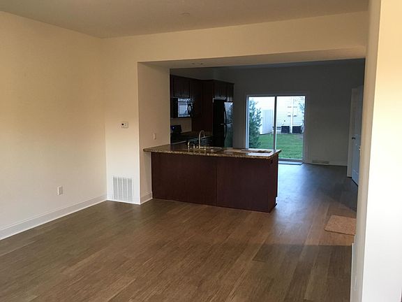 Living Room with LVT Flooring looking towards Kitchen Area