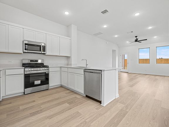 Kitchen in the Birch home plan by Trophy Signature Homes - REPRESENTATIVE PHOTO