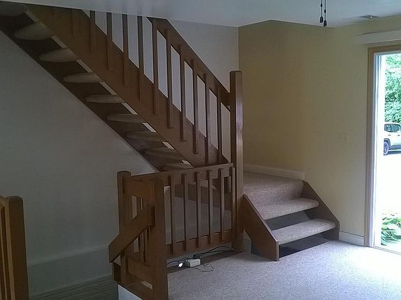 Main living room with view of stairway to bedrooms and lower level.