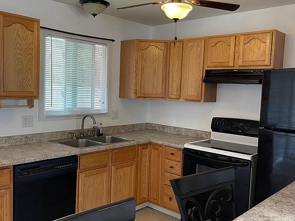 Kitchen has fresh paint, dishwasher, stove, refrigerator, breakfast bar with stools included.