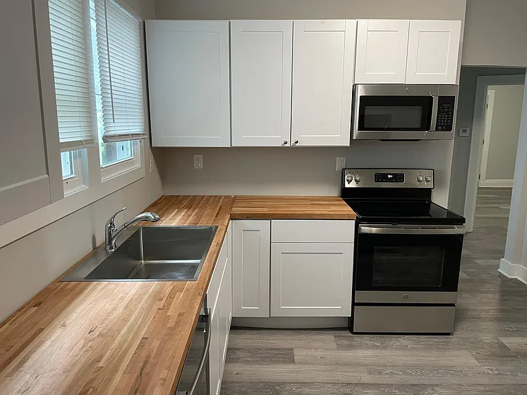 All new Kitchen. White shaker cabinets, butcherblock countertops & GE Stainless Steel Appliances.