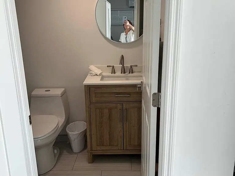 Bathroom with toilet, cabinet for storage, and basic essentials.