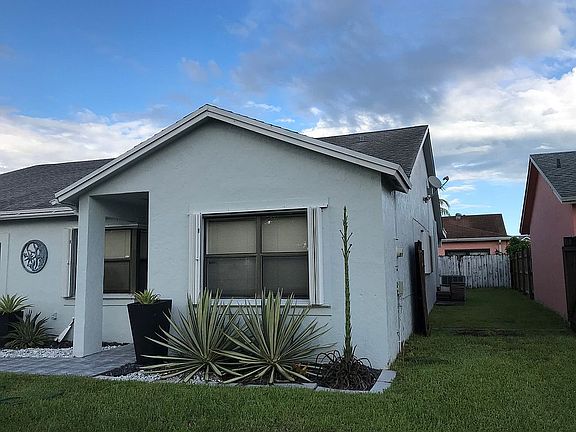 Side of house with open gate
