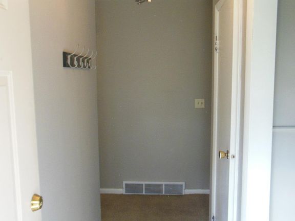 Entry way with new flooring, chandelier, and kitchen is immediately to the right when you walk in