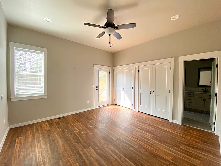 Large main bedroom with exit/ entry to back deck which looks out at Loon Lake!