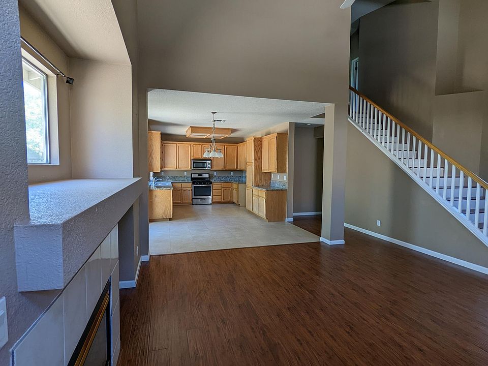 living room and kitchen
laminate living room flooring
tile kitchen flooring with granite counter top