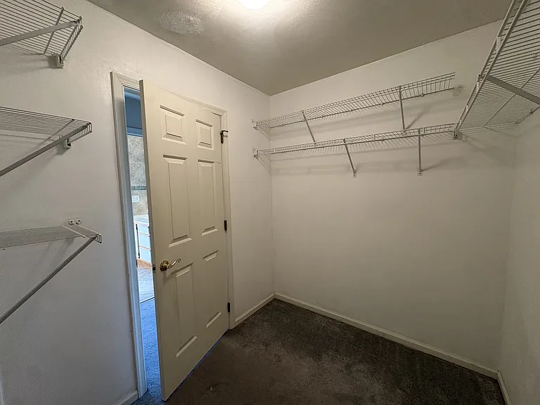 Primary bedroom walk-in closet