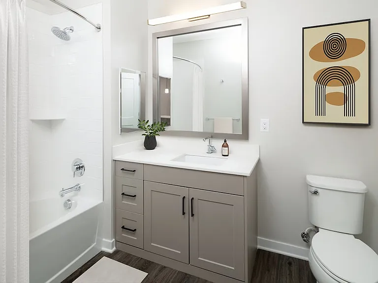 Upgrade Collection bath with quartz countertops, grey cabinetry, and hard-surface flooring