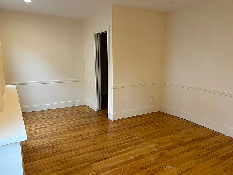Larger bedroom, view from corner across from door, showing closet.