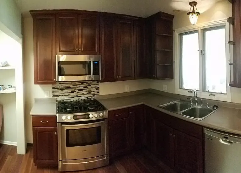 Kitchen area with washer and dryer hook-up.