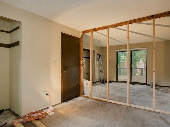 Bedrooms are under construction. Far bedroom has sliders to deck.