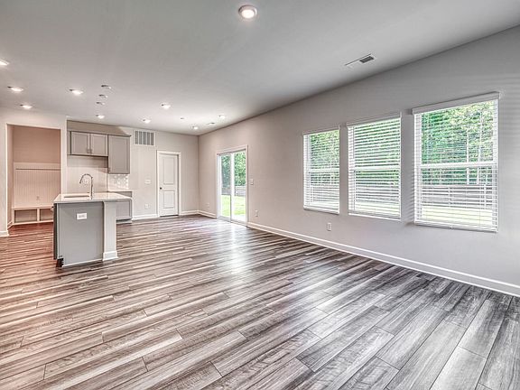 Large windows allow light to flood into the open-concept living space.