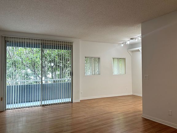Livingroom and dining room with view to private balcony