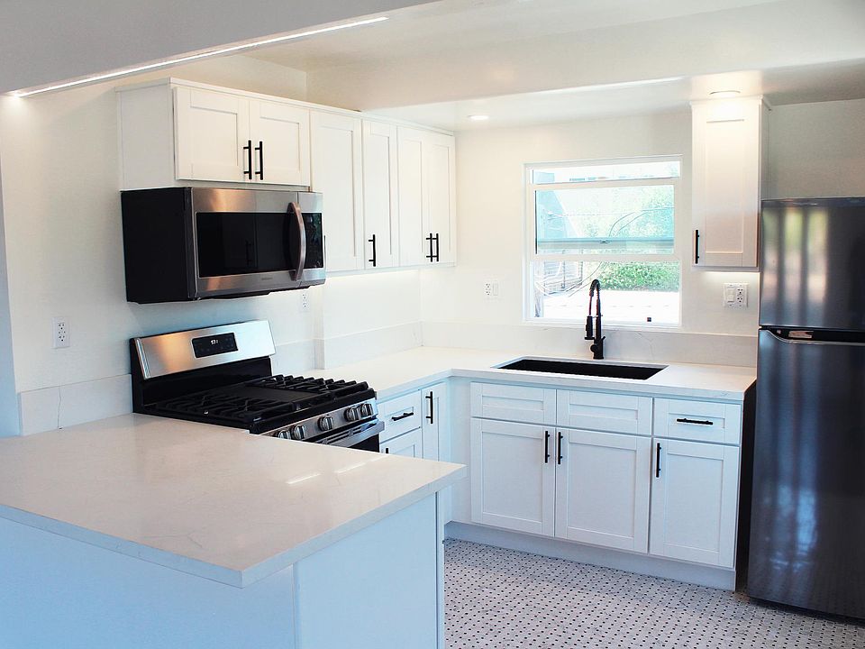 Large, Fully-Remodeled Kitchen with Marble Counter Tops and High-End Appliances.