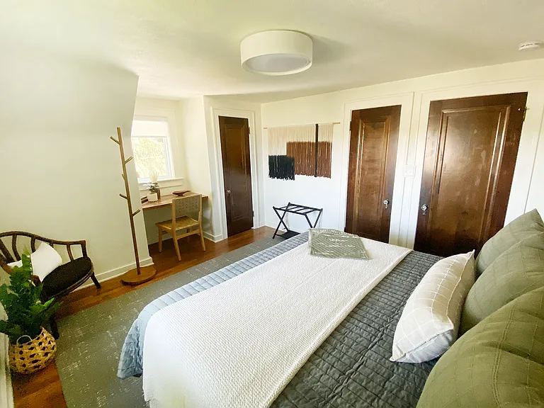 Light filled and cozy this bedroom can sleep three with foldout twin bed provided in closet. Designated work area in front of window.