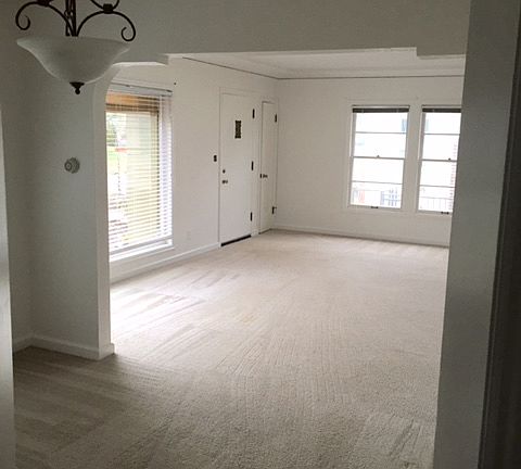 Living room looking from the dining room towards the front door