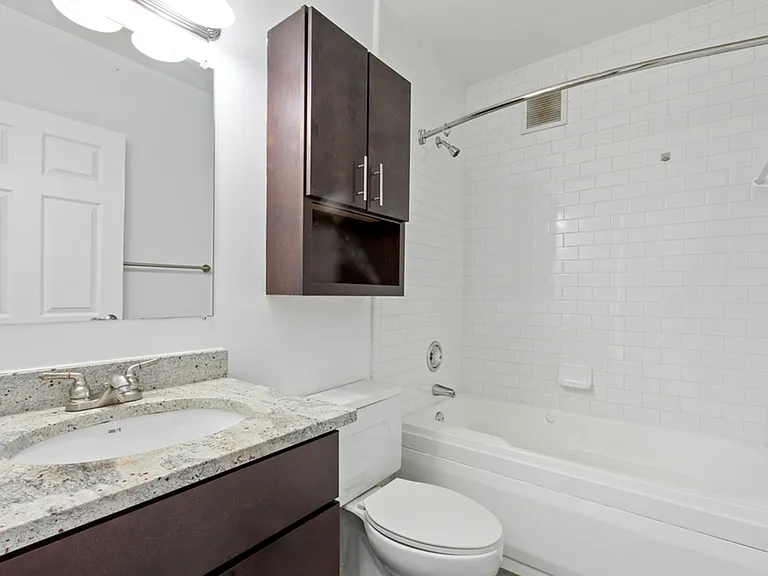 Bathroom with granite countertop and storage