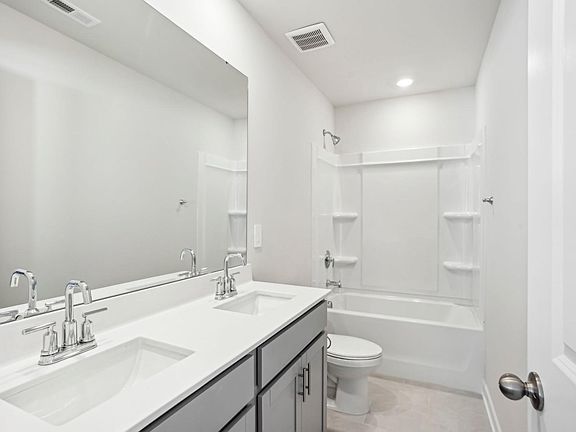Our secondary bathroom features an oversized tub and mirror.
