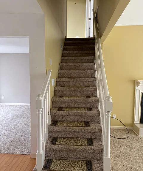 Stairs to two other rooms and full bathroom.