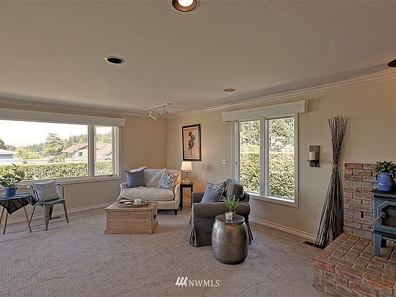 Light filled family room with wood burning fireplace.