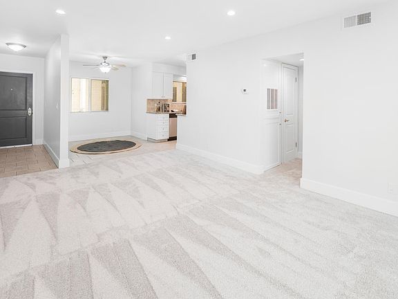 Side unit T9- View of entry, dining area, kitchen & hall from living room. Clean & new!