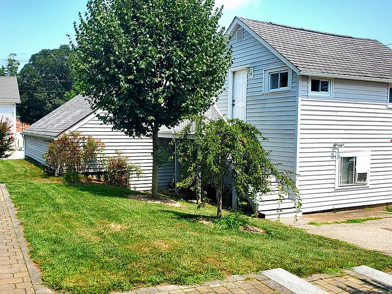 Stairs (behind trees) leading up to private porch and apartment.