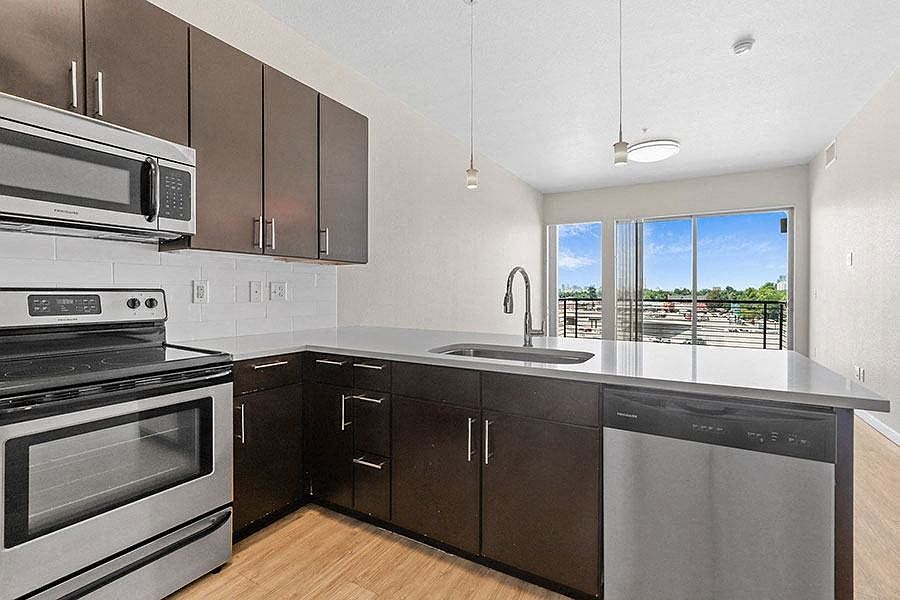 Kitchen features a beautiful view of the living space and the natural beauty outside