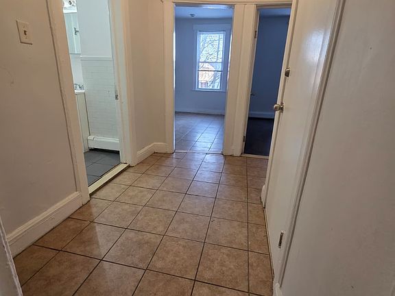 past living room, hallway coonecting other bedrooms, kitchen, bathroom and pantry