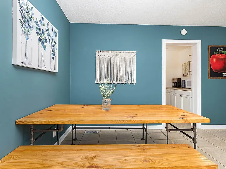 Custom made dinning table and benches. Pull it out and bring the two game chairs in to add two more to the party. Seats 8 comfortably.