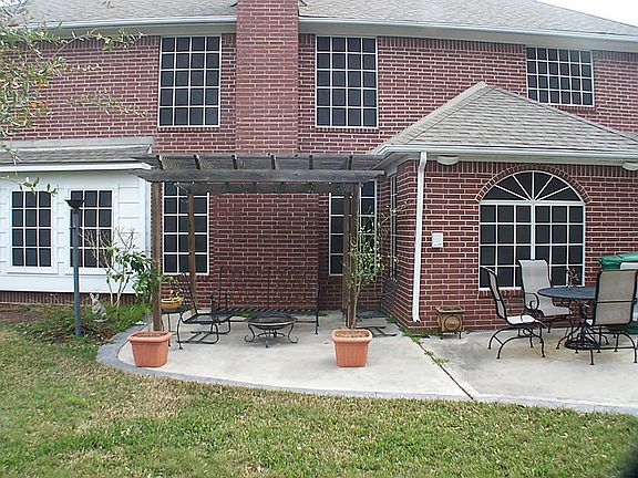 Over sized patio with an arbor, large pool sized yard