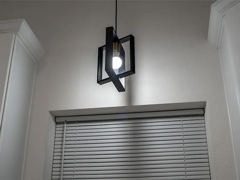 Chandelier light fixture above kitchen sink.