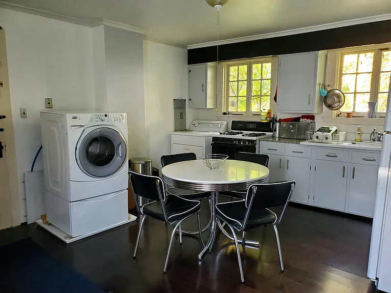 BIG Eat in Kitchen. Sunny. New Sept '24 gas stove. Windows. Washer and Dryer. French Fridge. Granite counters. 1920 Barn Find Farm Sink.. Dark Hardwoods. Leads to covered patio overlooks big grassy back yard with mature trees. Fenced patio-small yard.