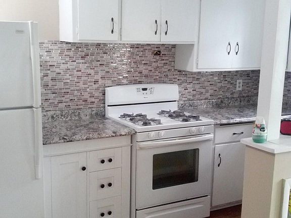 Kitchen with new backsplash and countertops installed