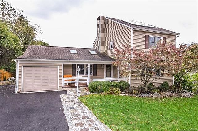Front of House with covered front porch - 5 car driveway and garage