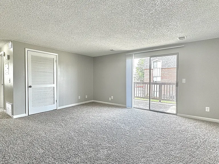 A spacious living area filled with natural light, offering a comfortable and inviting space to relax or entertain.