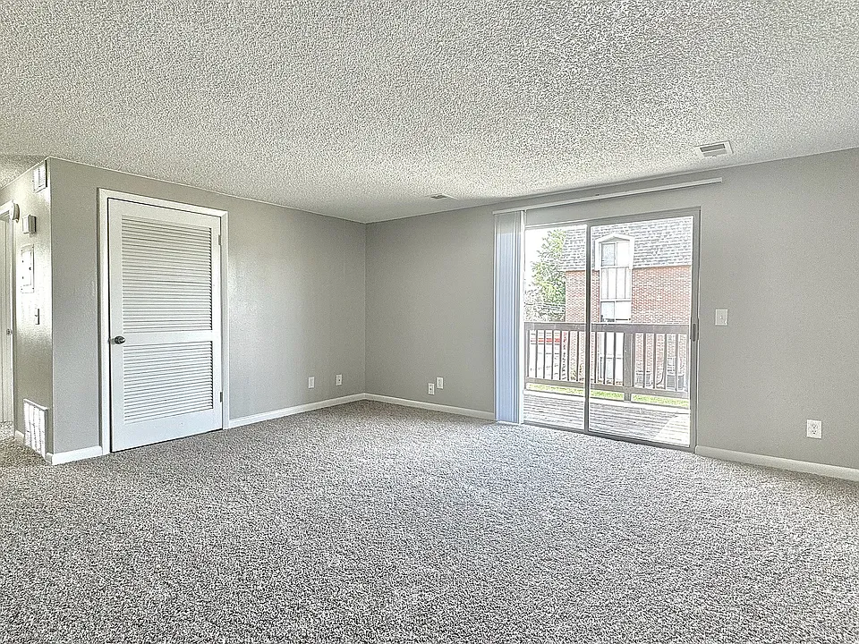 A spacious living area filled with natural light, offering a comfortable and inviting space to relax or entertain.