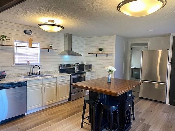 Open floor plan with stainless appliances.