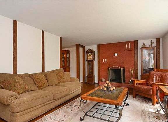 Formal living room with woo...