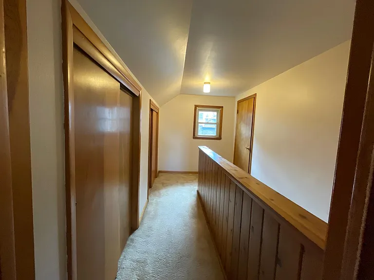 Upper level hallway with storage to the side