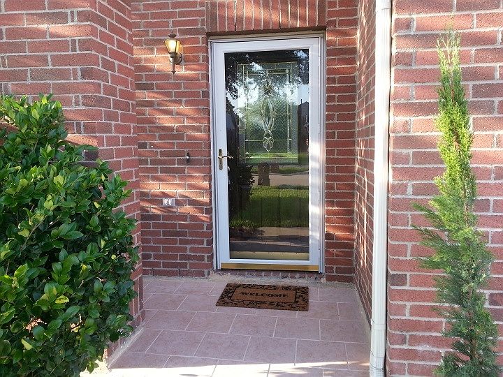 Nice front entry with extrs strom glass door.