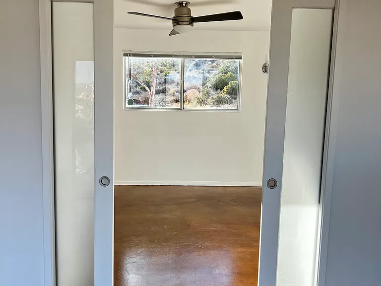 bedroom off the dining room with pocket doors